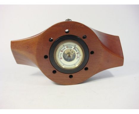 A mahogany propeller boss inset aneroid barometer:, the stamped 'LHT D7 16 P 6 96' and numbered '7626' to front, 44cm wide 