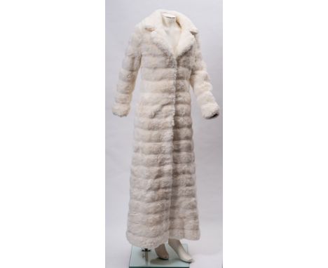 A collection of vintage clothing and textiles: including white faux fur full length coat and a similar shawl, two wedding dre