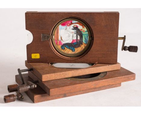 Four hand painted rack and pinion magic lantern slides:, comprising a windmill by Newton & Co,  a water mill, a chromotrope a