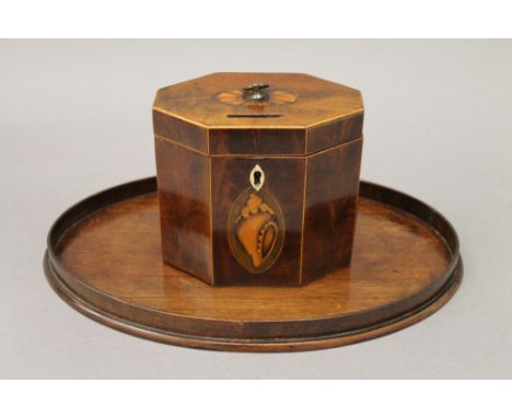 A George III mahogany octagonal tea caddy with shell inlay and a 19th century mahogany oval shell inlaid card tray. The forme