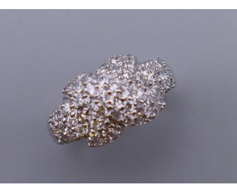 A silver cubic zirconia crossover ring. Ring size O/P.