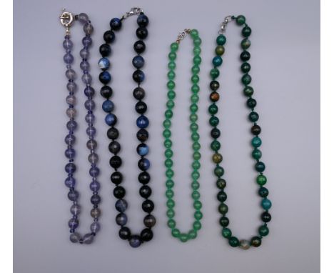 An agate facet cut bead necklace, a jade bead necklace and two others. The former 45 cm long.