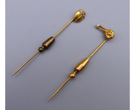 An unmarked gold bird form stick pin and a scarab beetle form stick pin. The former 7 cm high. 6.4 grammes total weight.