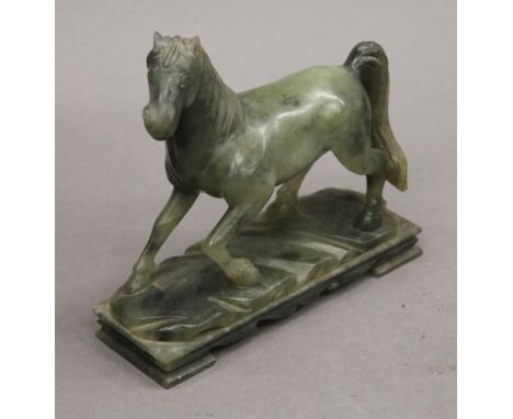 A carved jade model of a horse. 15.5 cm wide.