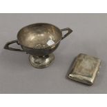 A silver cigarette case and a silver trophy cup. The former 8.5 cm high. 7.6 troy ounces.