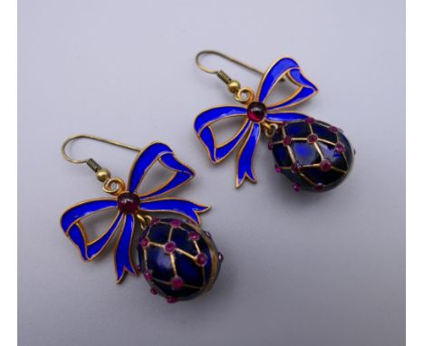 A pair of enamel decorated egg form earrings. 3 cm high.