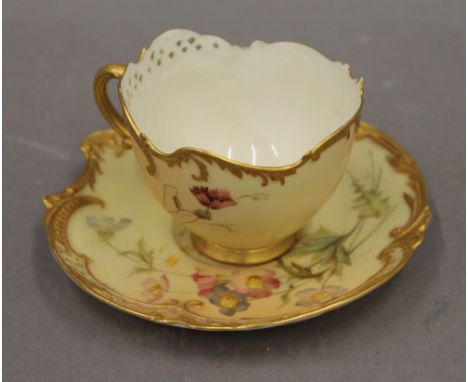 A Royal Worcester blush ivory cup and saucer. The cup 10 cm wide.