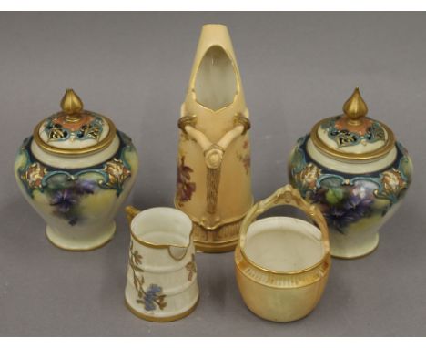 A Royal Worcester blush ivory ewer, a jug, a basket and a pair of Hadley's Worcester pot pourri jars. The former 15 cm high.