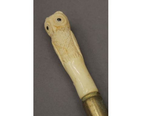 A walking stick with owl form bone handle. 90 cm high.