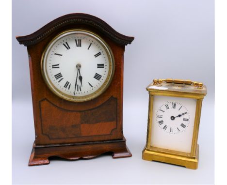 An Edwardian mahogany mantle clock and a carriage clock. The former 20 cm high.