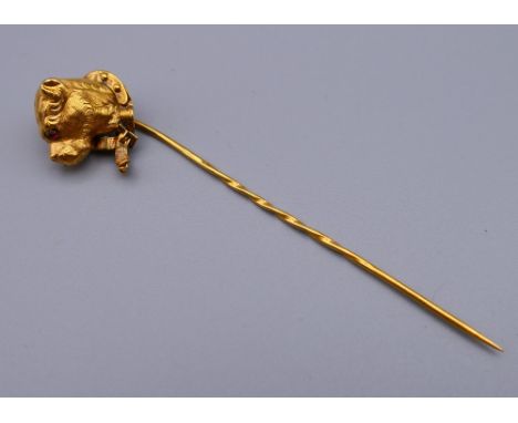 An unmarked gold dog form stick pin. 8.5 cm high.