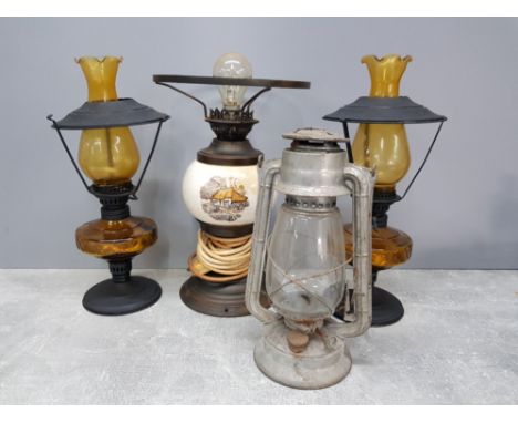 A pair of metal and amber glass oil lamps together with vintage metal lantern plus a table lamp