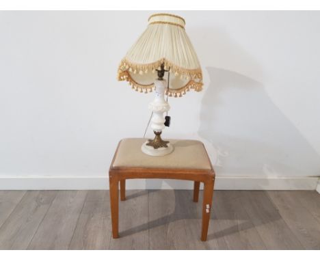 An alabaster table lamp with cream tassled shade, and a teak stool with drop in seat.