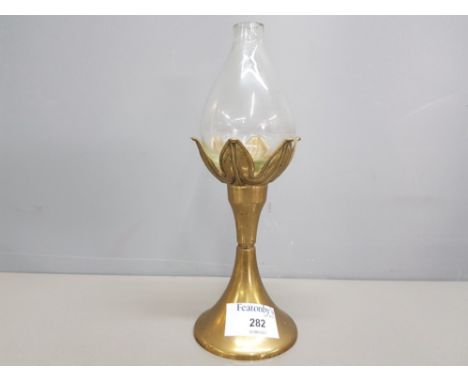 A 20th century brass oil lamp and hand blown glass reservoir, with mark to base 21cm.