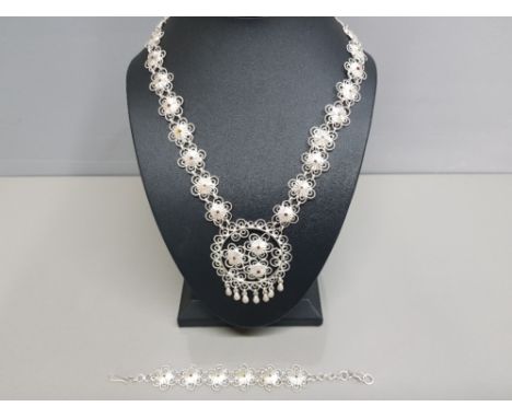 A silver middle eastern style necklace and bracelet with enamel decoration, 46.3g gross.