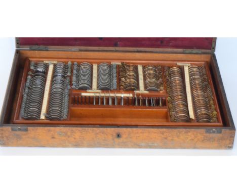 An Edwardian mahogany cased optician's lens display case, fitted with a tray interior containing various separate lenses toge