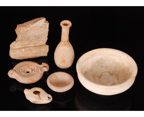 A Roman terracotta oil lamp, width 12.5cm, another smaller 8cm, a small bottle vase, four pieces of 2nd Century tesserae, var