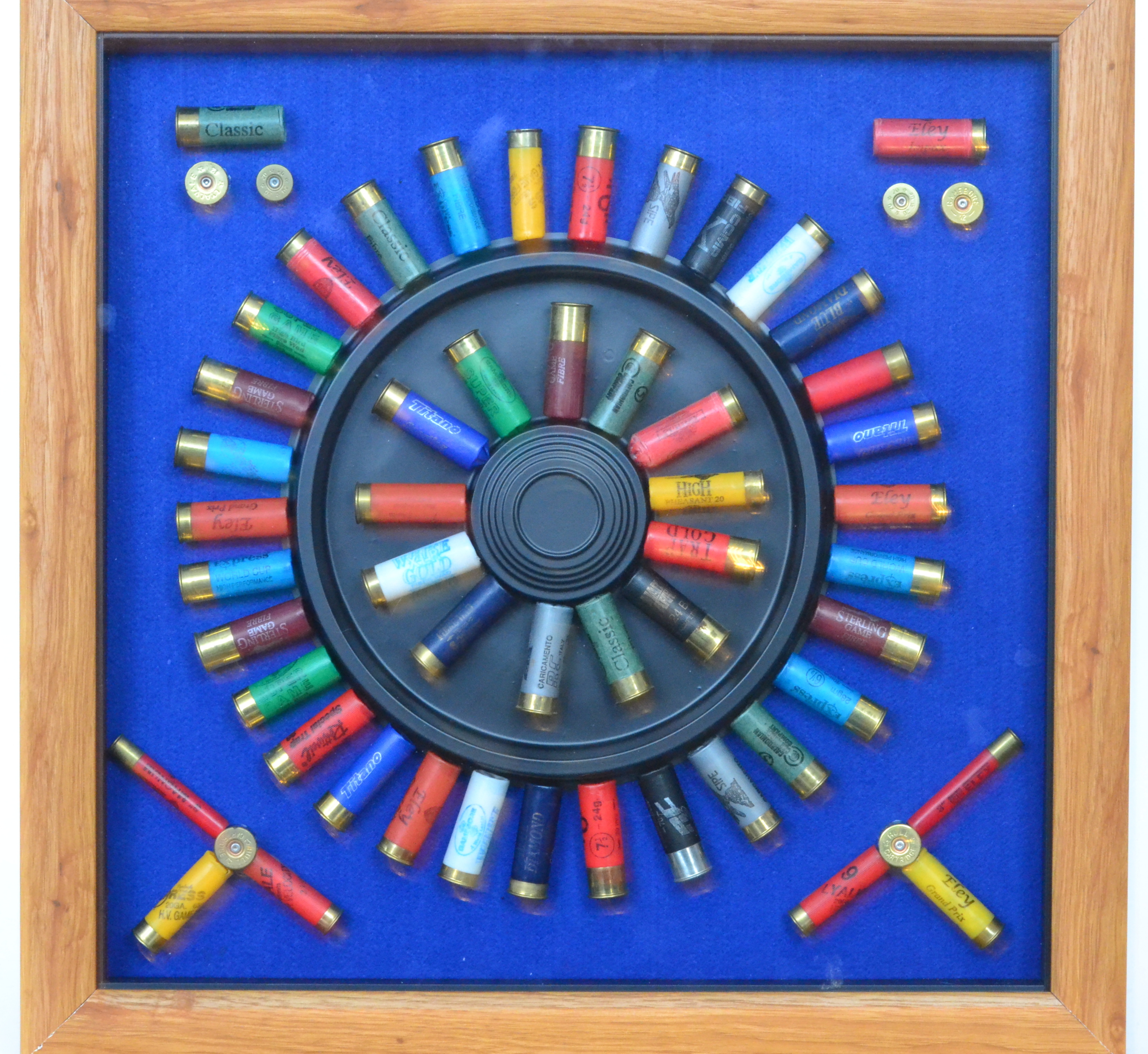 A modern shotgun cartridge display board of radiating formto a clay