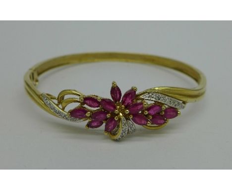A 9ct gold, ruby and diamond bangle, 10.1g
