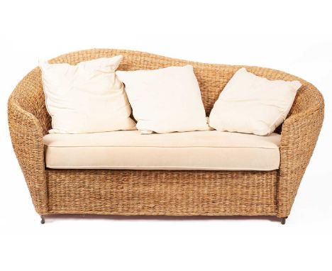 A woven rush two-seat conservatory sofa, with inscrolled arms enclosing a loose cushioned seat, 198cm wide