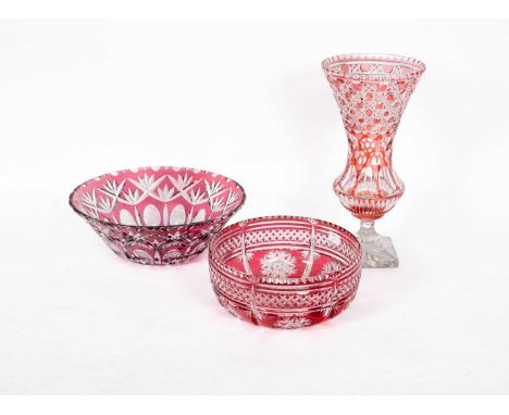 A ruby flash clear glass trumpet vase and two similar bowls, the vase 34cm high (3)