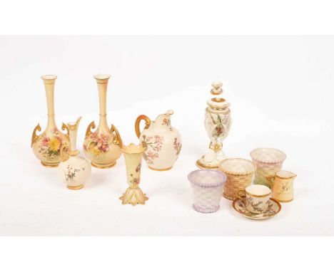 A group of four Royal Worcester flower-decorated blush ivory vases and ewers, a vase on three bird feet, a small flower-form 