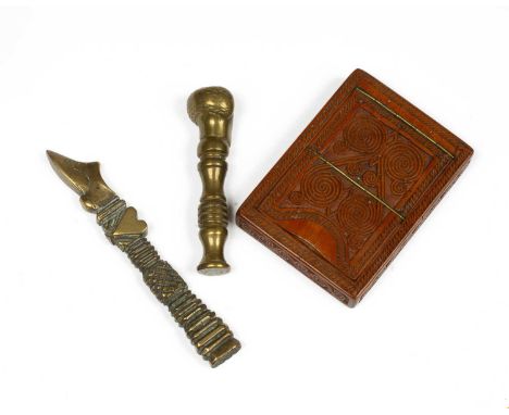A wooden carved foldout compact mirror and two brass pipe tampers (3)