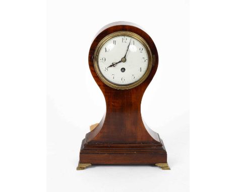 A mahogany balloon mantel timepiece, white enamel dial, French drum movement and lever platform, on brass ogee feet, with key