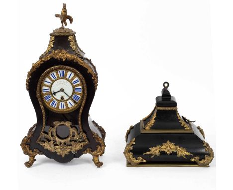 A gilt metal mounted ebonised case mantle clock, the waisted case surmounted by a cockerel, the white enamel dial with Roman 