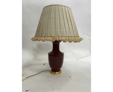 A Chinese style table lamp, the baluster vase of sang de boeuf glaze, fitted for electricity, 81cm high including pleated sha