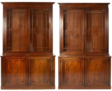 A George IV mahogany bookcase, the upper part enclosed by astragal glazed panel doors above cupboard doors on a plinth base, 