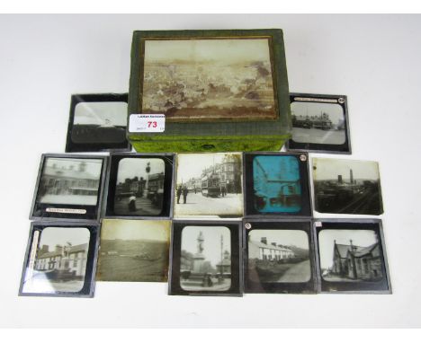 A Victorian trinket box bearing a photograph under glass depicting Brampton, together with a quantity of glass Magic Lantern 