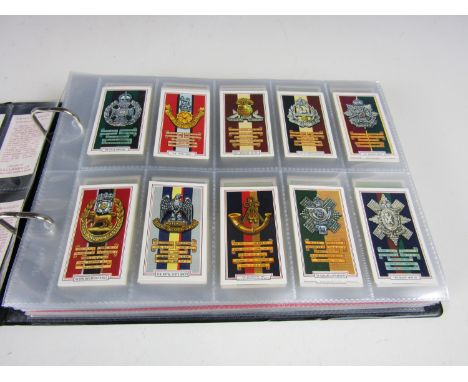 An album of vintage cigarette card series including Gallahers Army Badges, Wild Flowers, Butterflies and Moths and Garden Flo