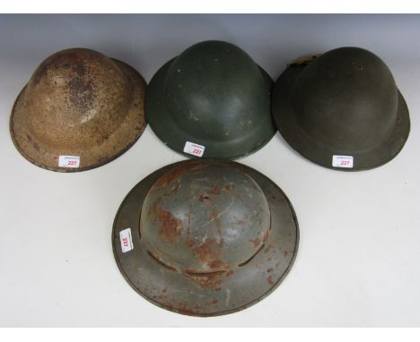 A Second World War Fire Watcher's helmet and three 'Tommy' helmets