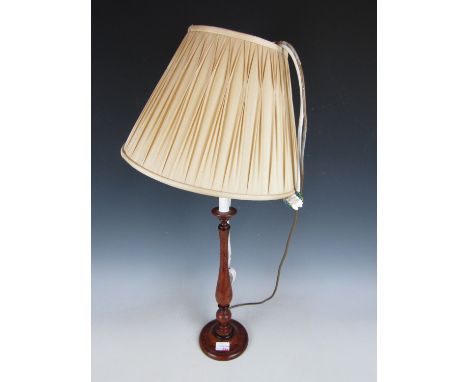 A turned wooden baluster table lamp