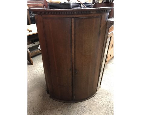 A 19th century oak bow fronted hanging corner cupboard with mahogany cross banding, 75 x 48 x 119 cm