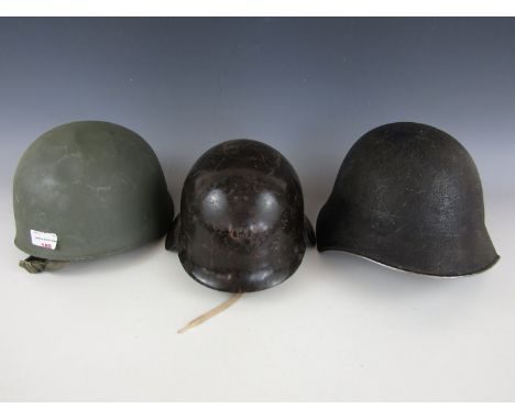A Swiss Model 1918, a Bulgarian and one other steel helmet