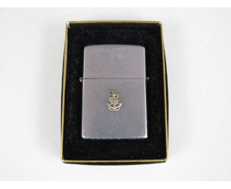 A boxed Zippo lighter with US Navy insignia