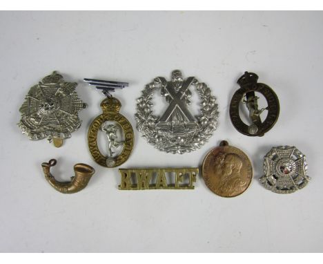 A small quantity of British army badges and a city of Carlisle 1935 jubilee medallion