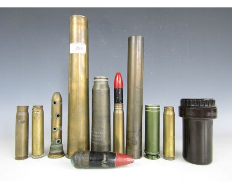 A quantity of brass shell cases, inert ammunition, a gun sight and German fuse case