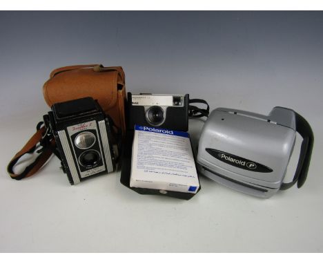 A vintage Polaroid camera together with other cameras
