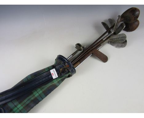 A quantity of vintage hickory-shafted and other golf clubs, together with a green tartan golf bag