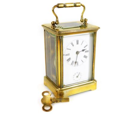 A late 19thC brass alarm carriage clock, the 5.5cm dial with Roman numerals and subsidiary Arabic second hand, revealing a tw