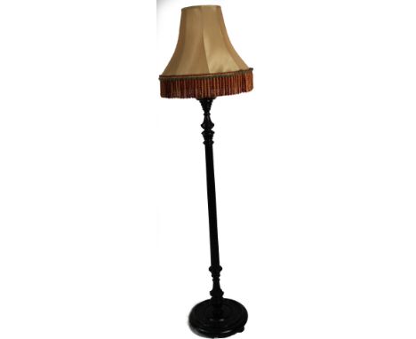 A carved and fluted standard lamp, with shade.