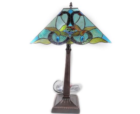 *An as new table lamp, with Tiffany style shade predominately in blue and green, 58cm H.