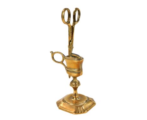 A brass wick cutter on stand, in two sections, with candlestick base and compressed circular handle, 20cm H.