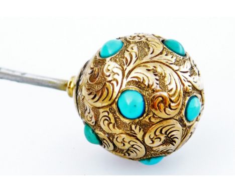 A Victorian stick pin, with bull design top, set with small turquoise stones and scroll design feathers, yellow metal, unmark