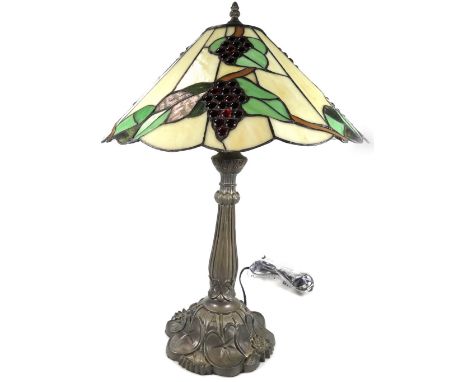 *An as new table lamp, with Tiffany style shade, set with berries and leaves predominately in red, green and cream, 67cm H.