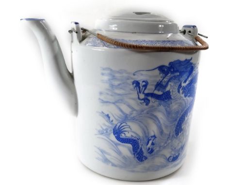 A Chinese blue and white porcelain teapot, of large proportion with entwined handles, decorated with a three clawed dragon, f