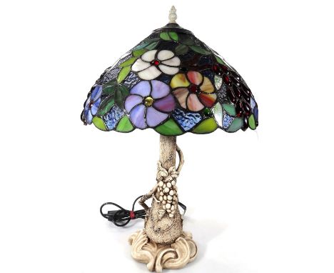 *An as new table lamp, with Tiffany style floral shade, predominately in red, blue and green, 59cm H.